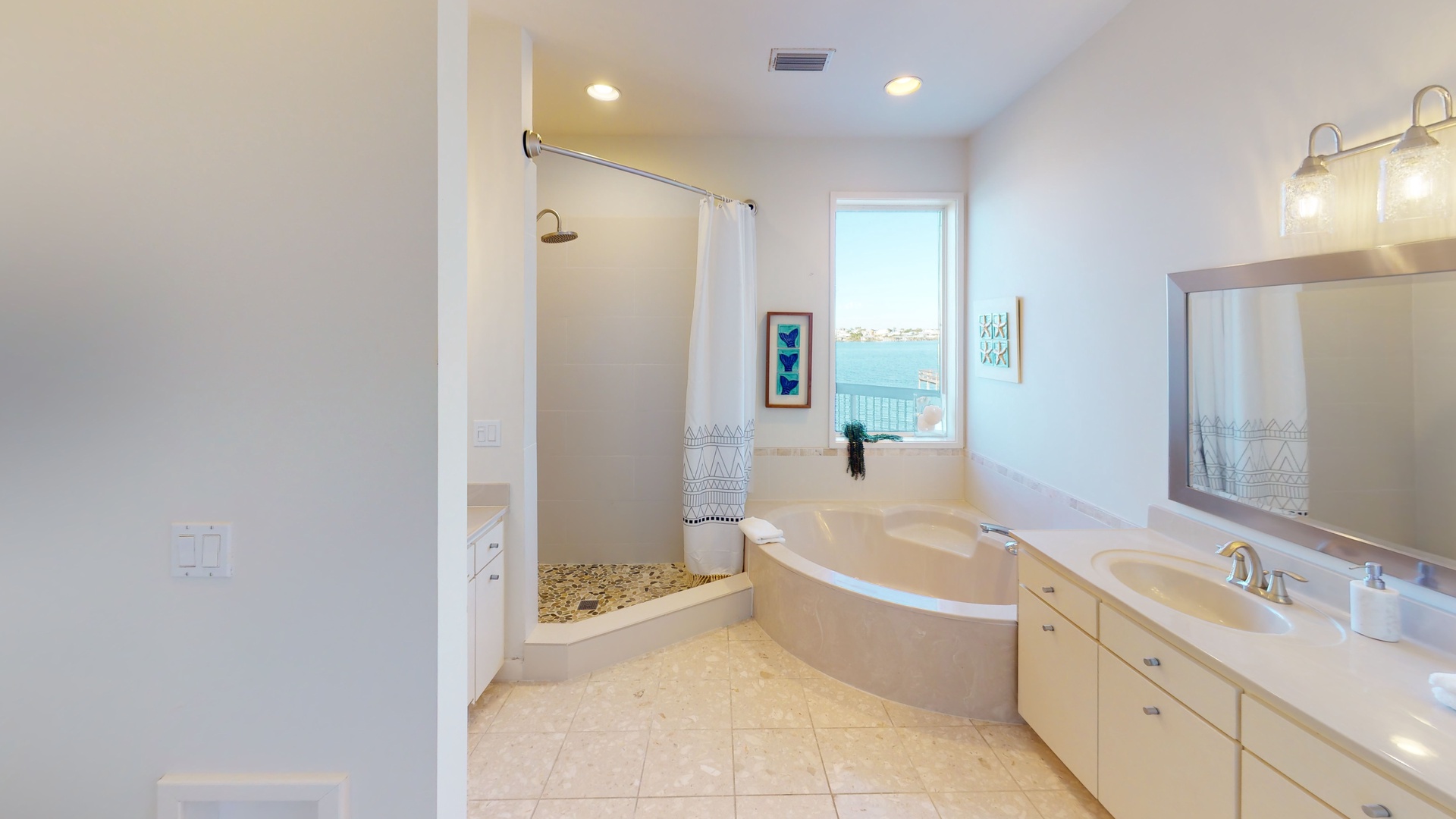 The private master bath features a garden tub and a walk-in shower