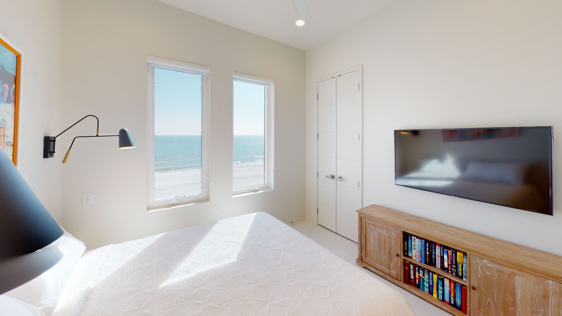 Bedroom 5 has a TV, Gulf views, stocked bookshelf, and a private bathroom