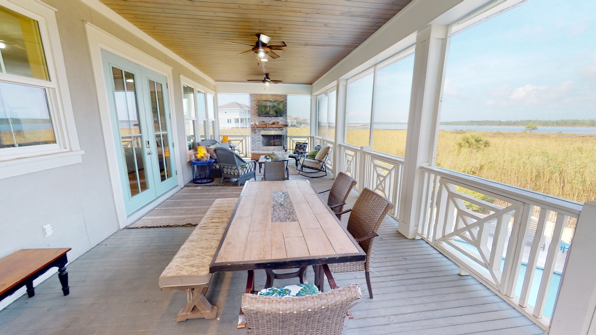 Large screened-in porch with Lagoon views and access to the pool deck below