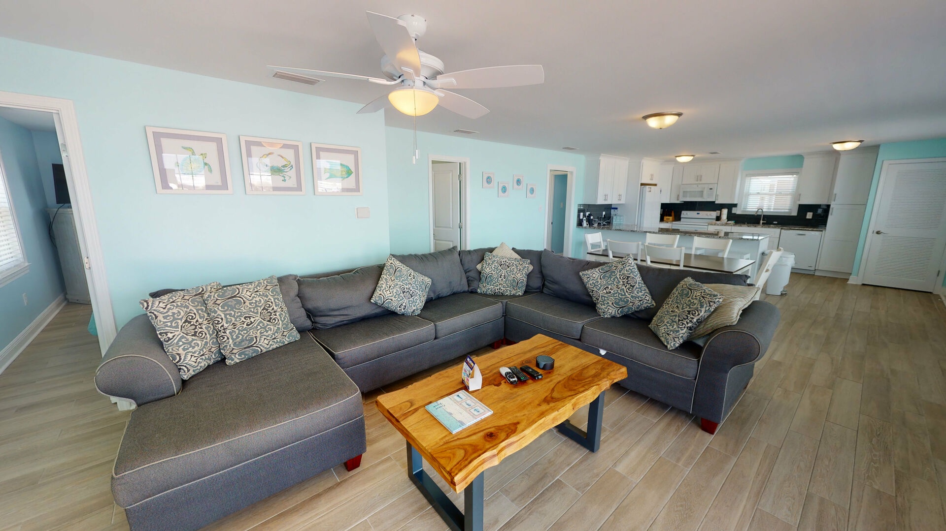 Living area features a large sectional that also doubles as a sofa sleeper for 2, TV, and access to the beach front deck