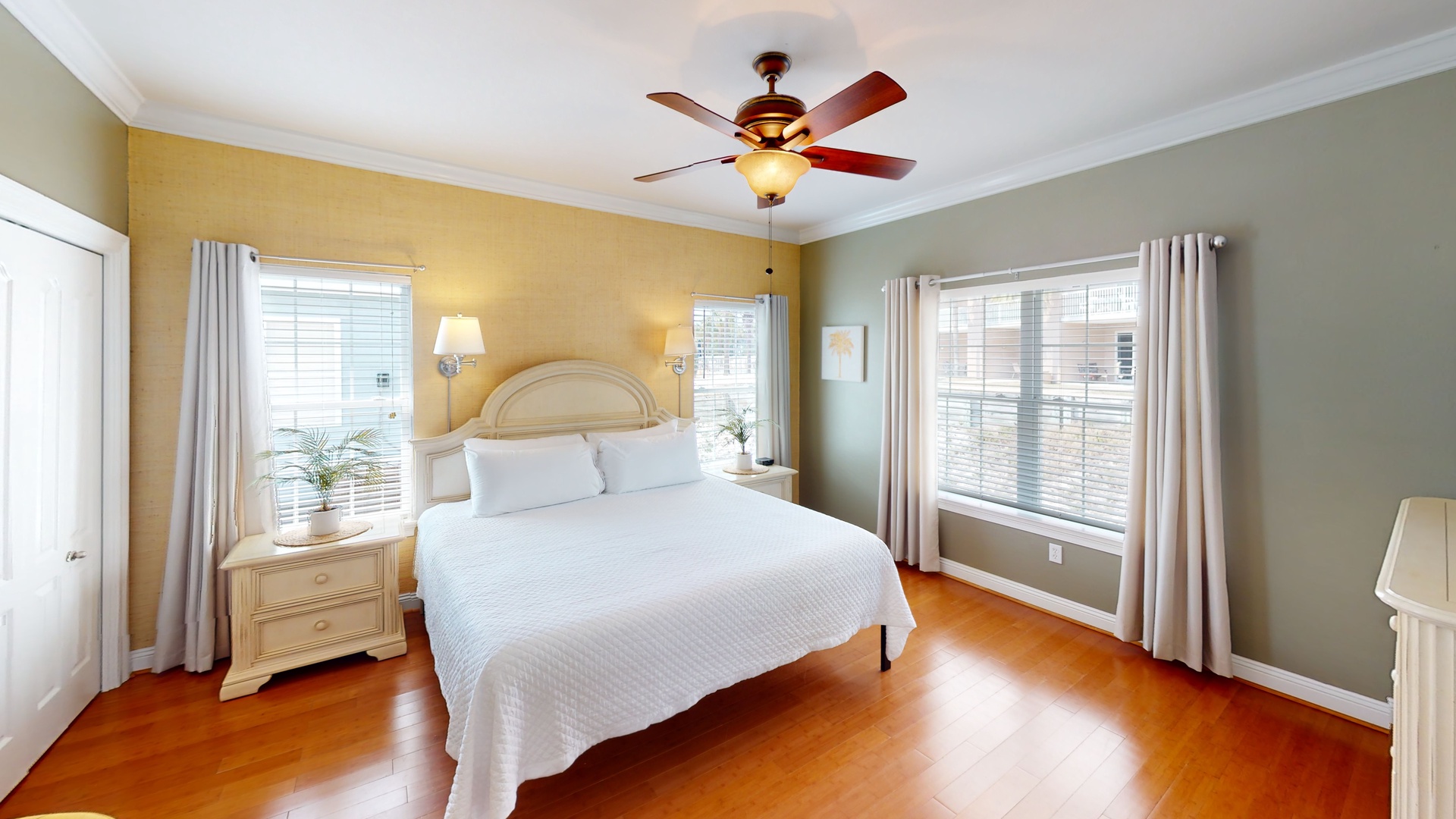 The Master bedroom features a king bed and a ceiling fan