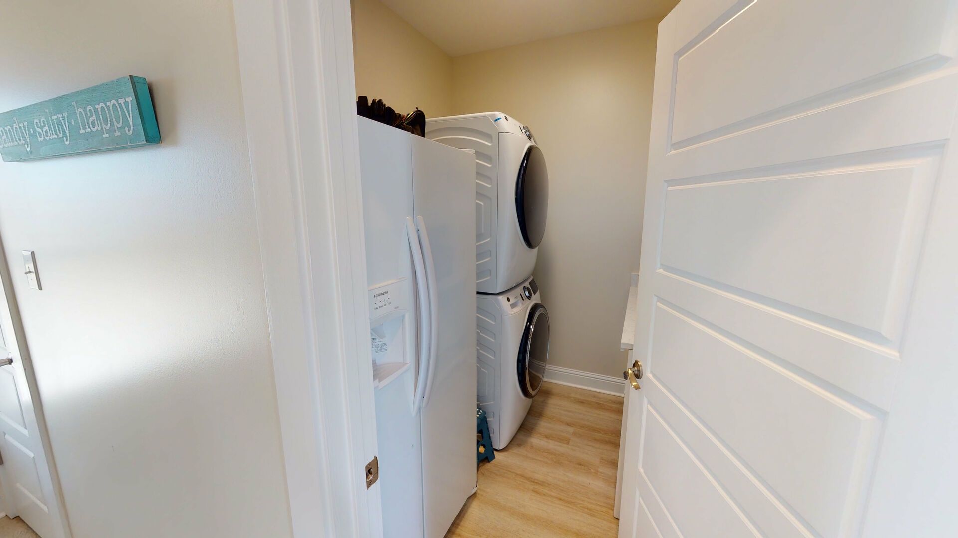 Laundry and extra refrigerator located on lower level