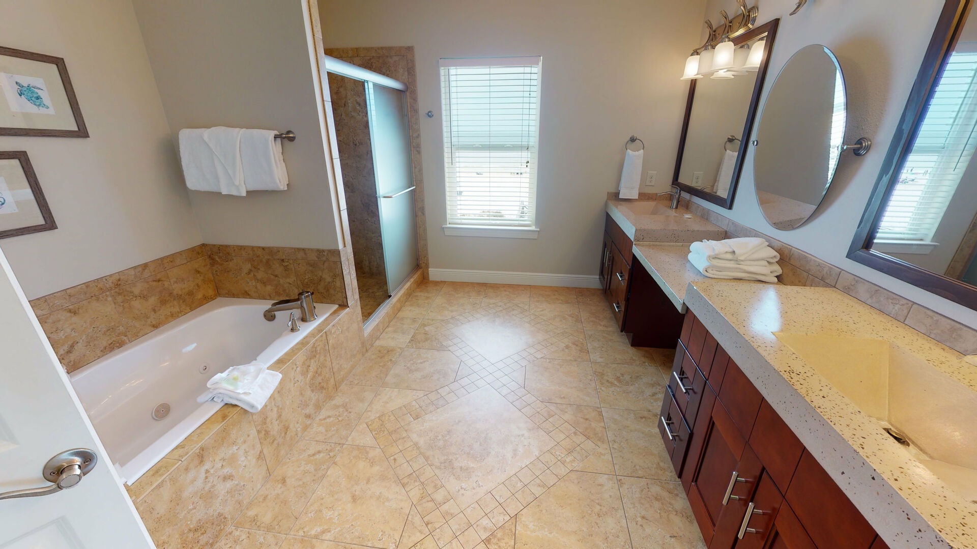 Private Master bath with a double vanity, walk-in shower and a soaking tub