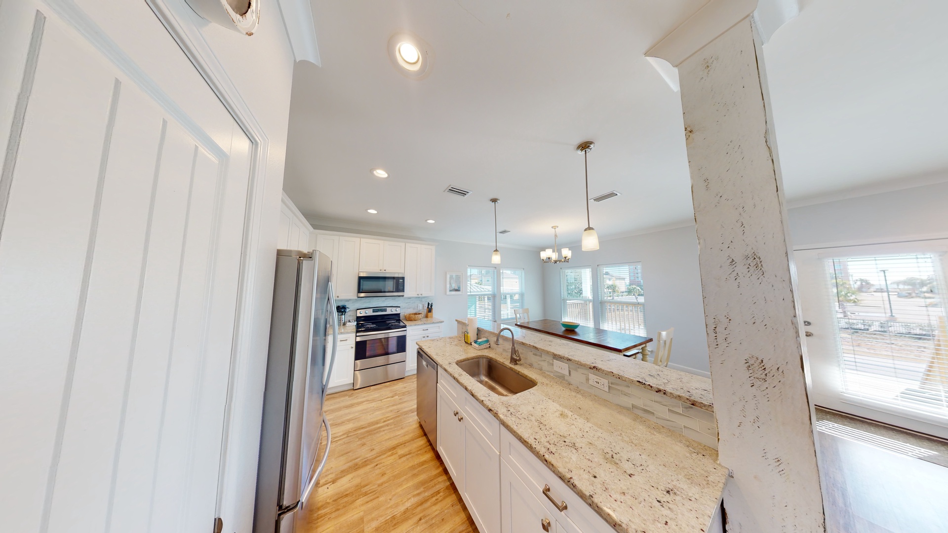The updated kitchen features stainless appliances, beautiful backsplash and stone countertops
