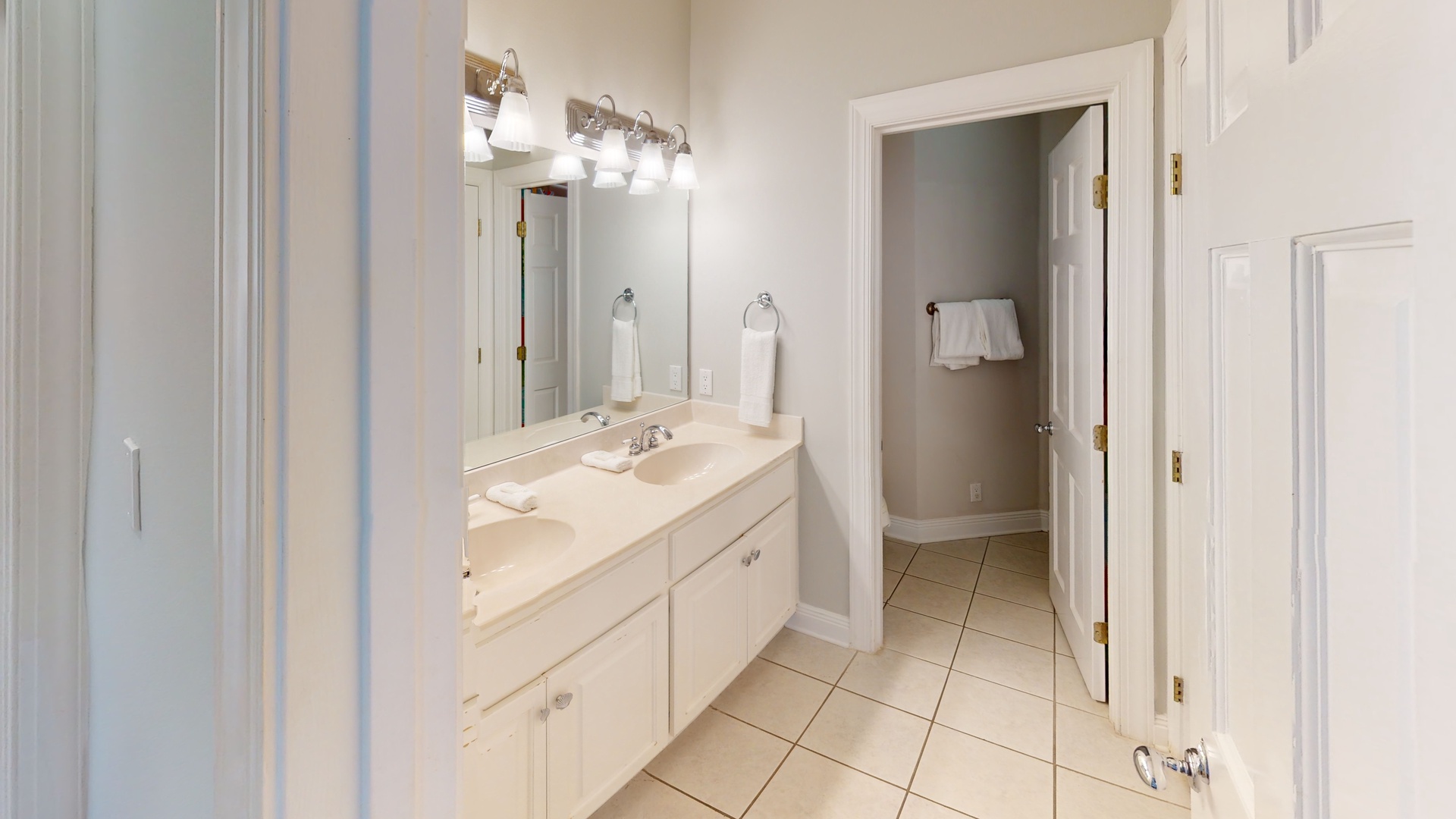 2nd floor shared hall bath with a double vanity and tub/shower combo