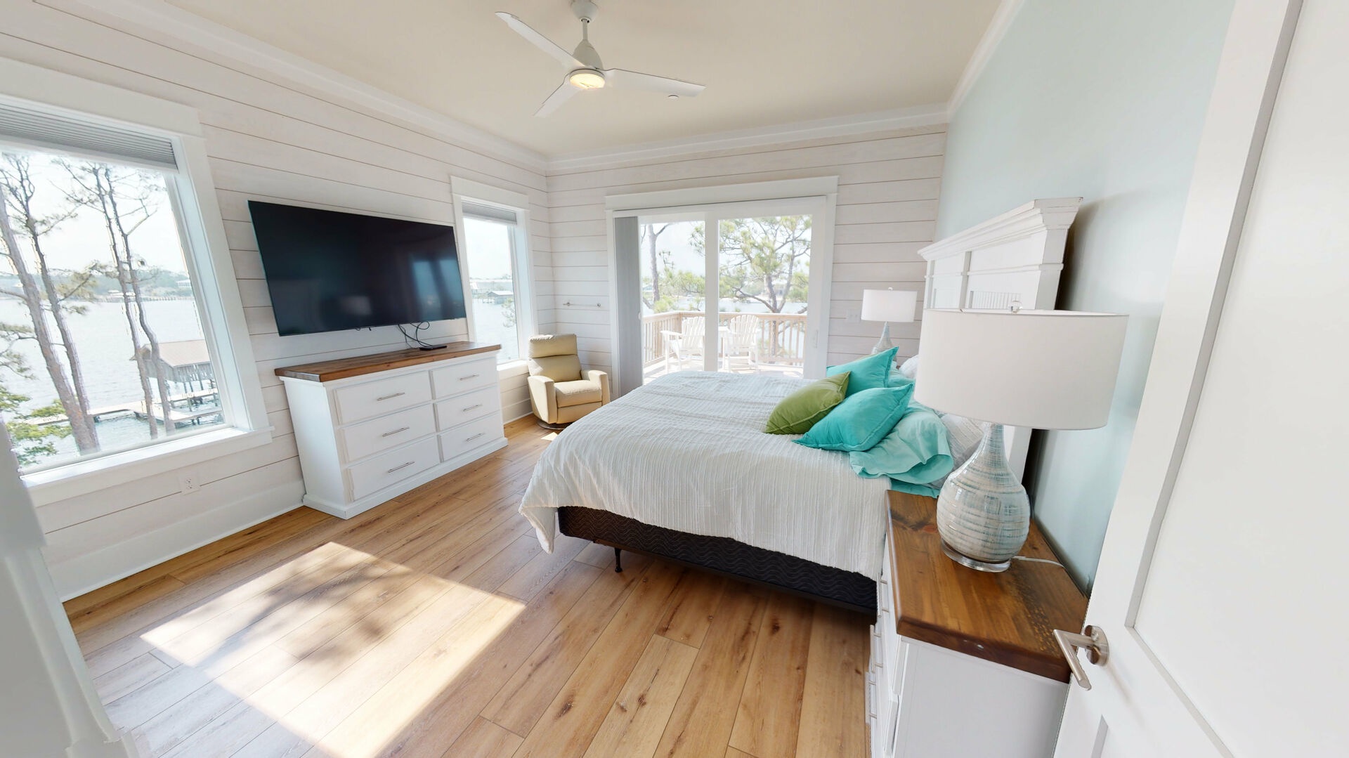 The master bedroom is on the 3rd floor and features a king bed, TV, private bathroom, water views and balcony access