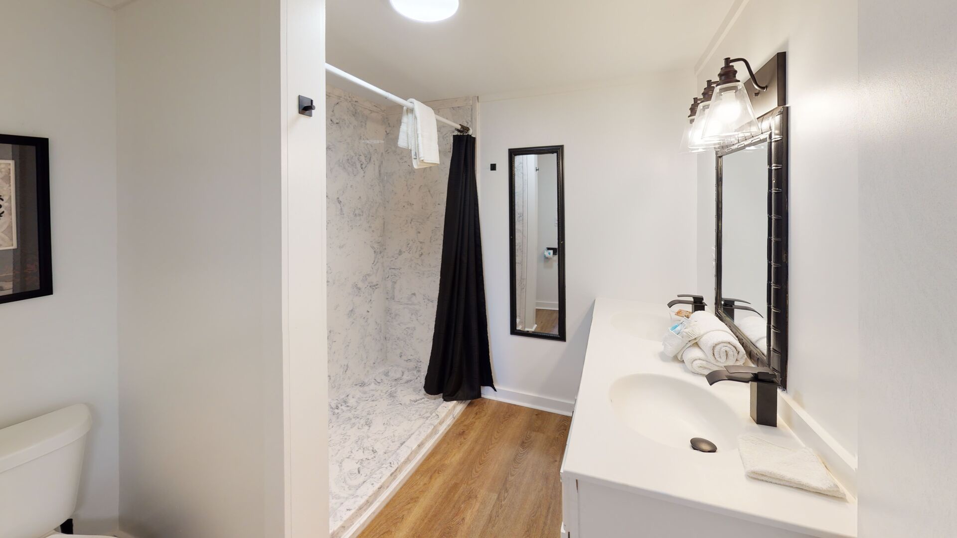 Shared hall bath with walk-in shower and double vanity
