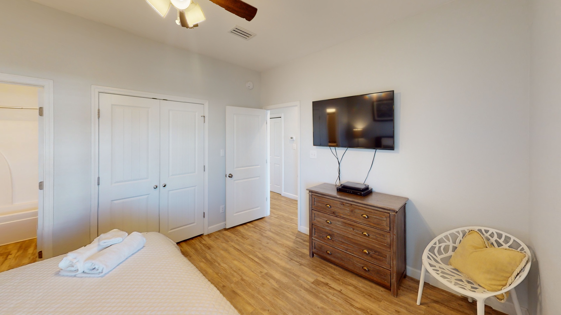 Bedroom 2 comes with a ceiling fan, TV and a private bathroom