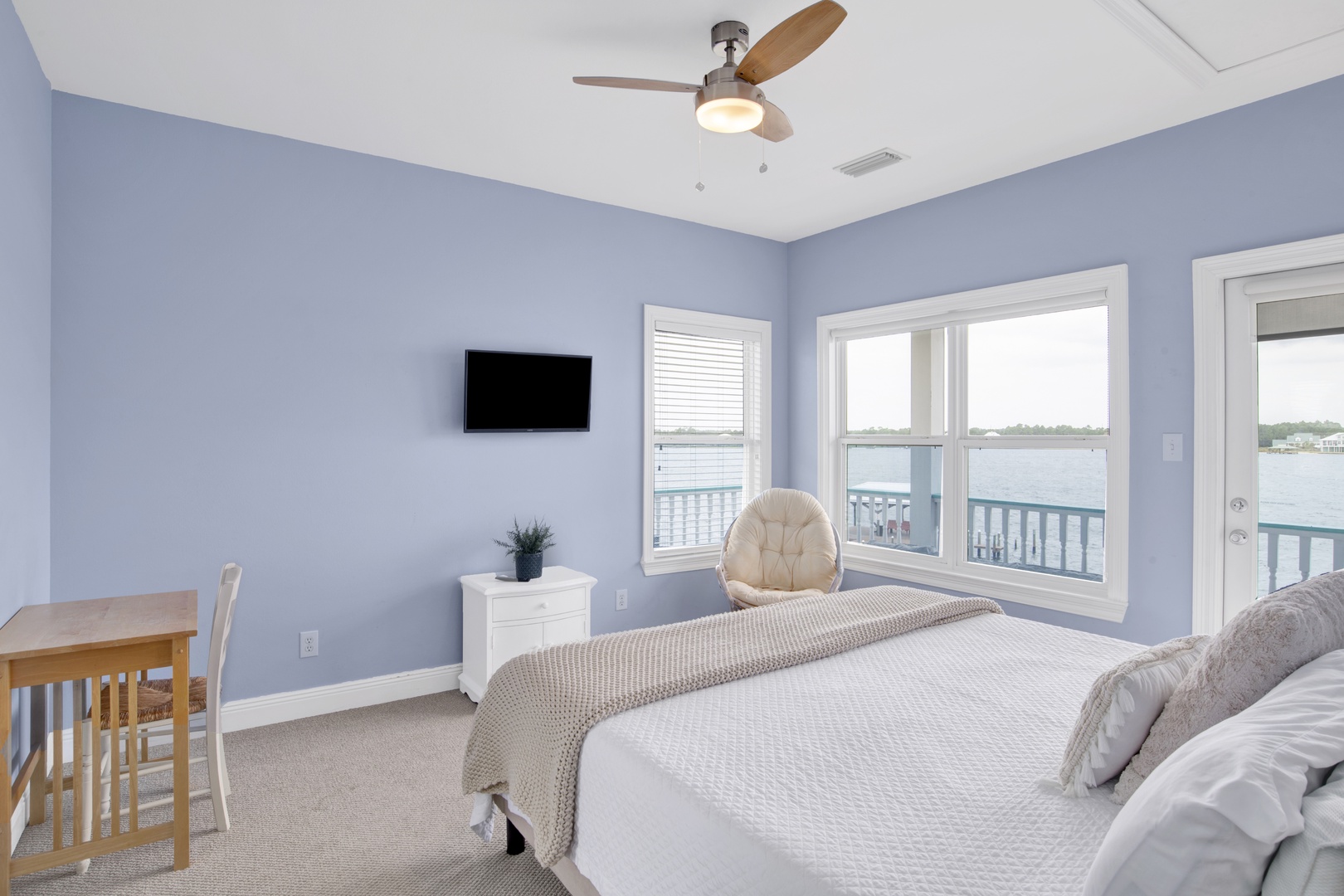 Bedroom 2 features a TV, ceiling fan, water views and a private bathroom