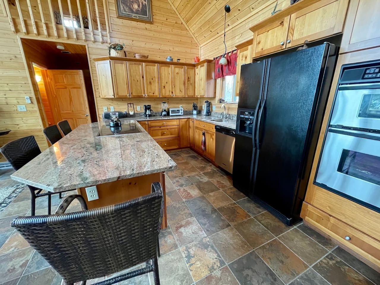 Your fully equipped cabin kitchen invites culinary adventures with granite countertops, stainless appliances, and rustic wood charm throughout.