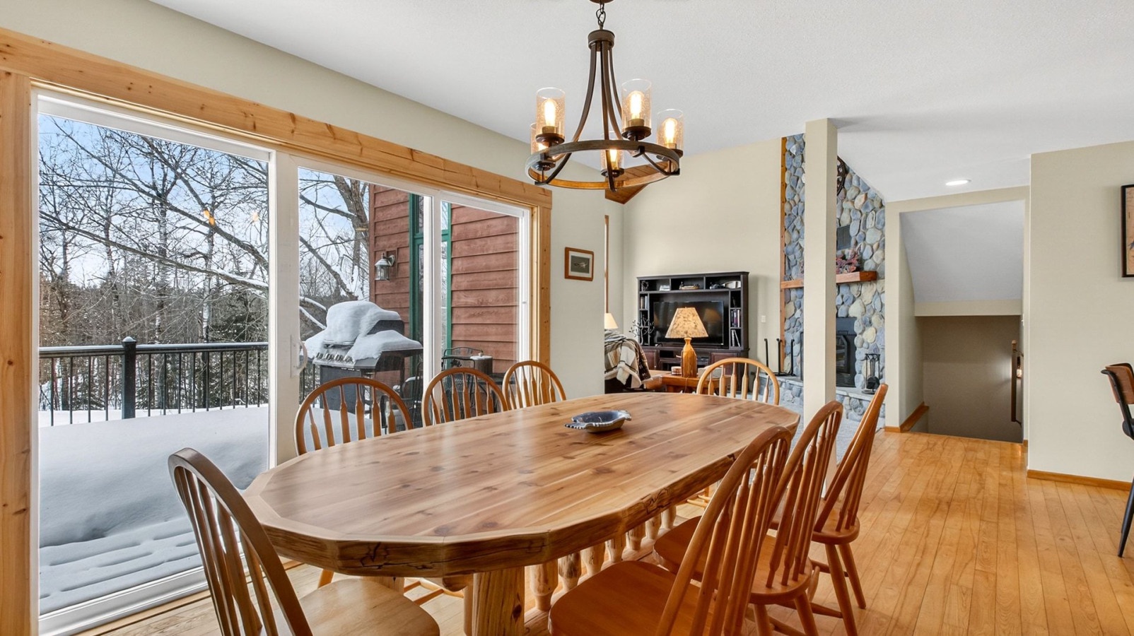 Gather around this beautiful wood dining table with mountain views and cozy fireplace creating perfect ambiance for your meals.
