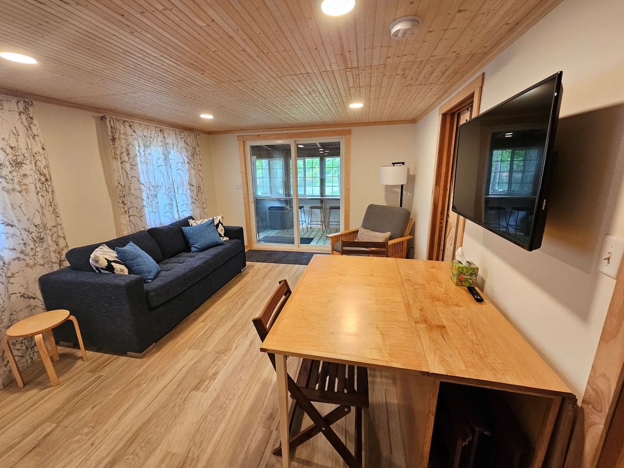 Unwind in your cozy living space with warm wood details, comfortable seating, and mountain views through the balcony doors.