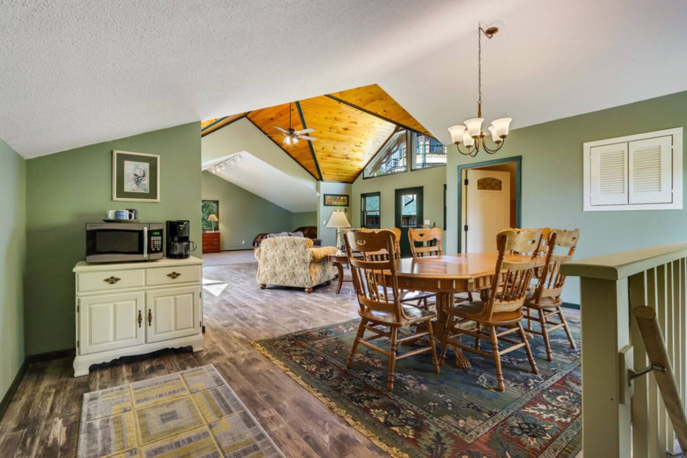 Relax in your spacious open living space with vaulted ceilings, warm wood beams, and comfortable dining for memorable meals together.