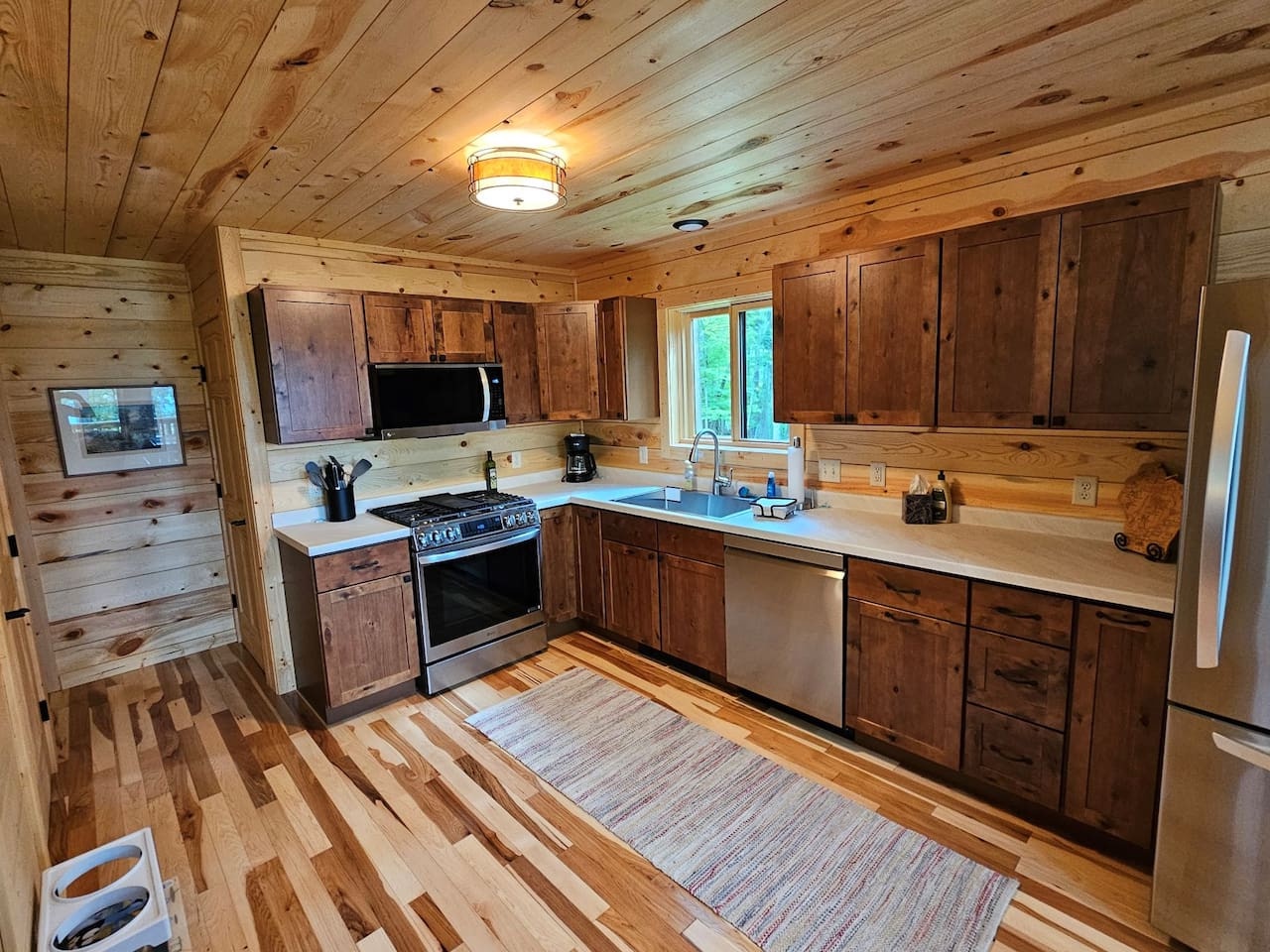 Your fully-equipped rustic kitchen blends cabin charm with modern convenience, featuring rich wood cabinetry and everything needed for memorable meals.