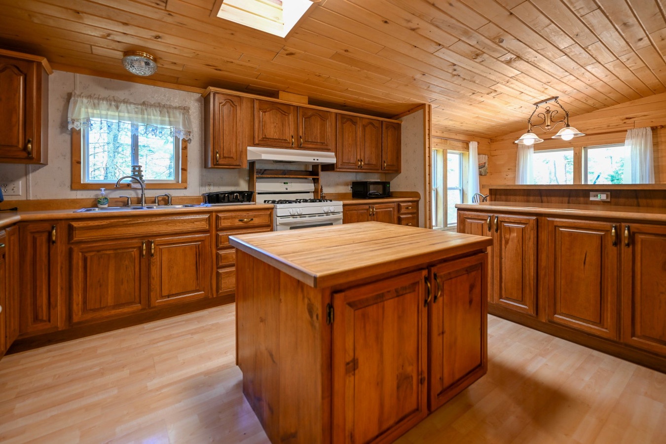 Step into your dream kitchen where warm wood cabinets and rustic charm meet modern convenience for memorable meal preparation.