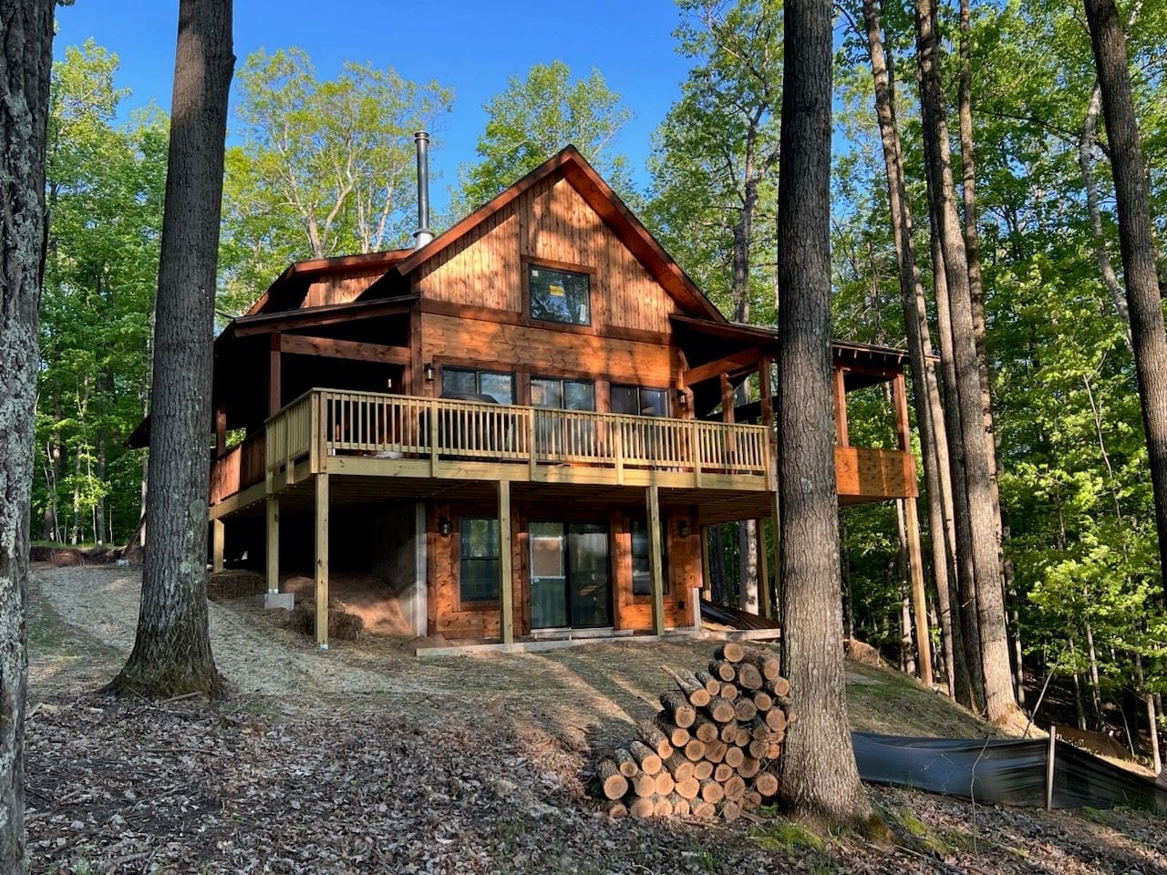 Charming wooden cabin nestled in pristine forest setting with spacious deck and natural surroundings for peaceful woodland escape.