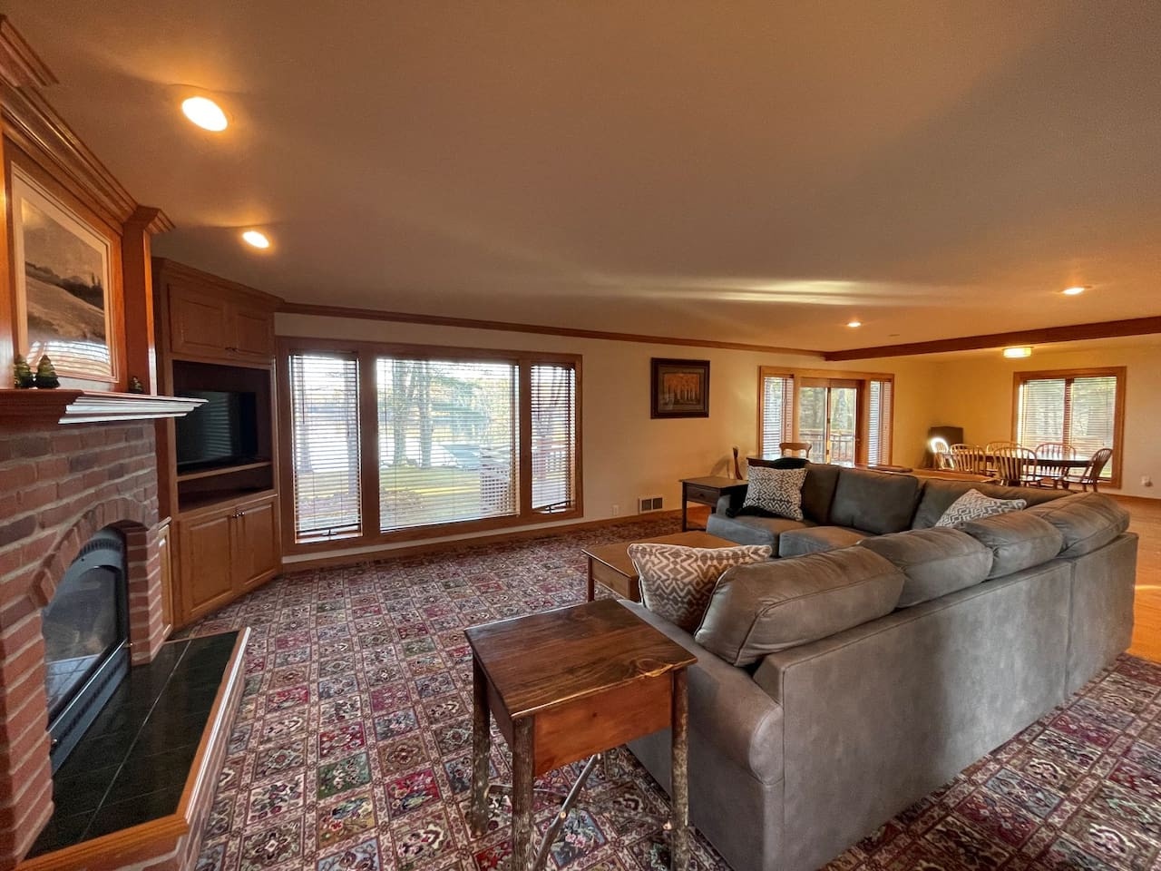 Sink into your spacious sectional while the fireplace crackles nearby. Traditional charm meets modern comfort in this inviting living space.
