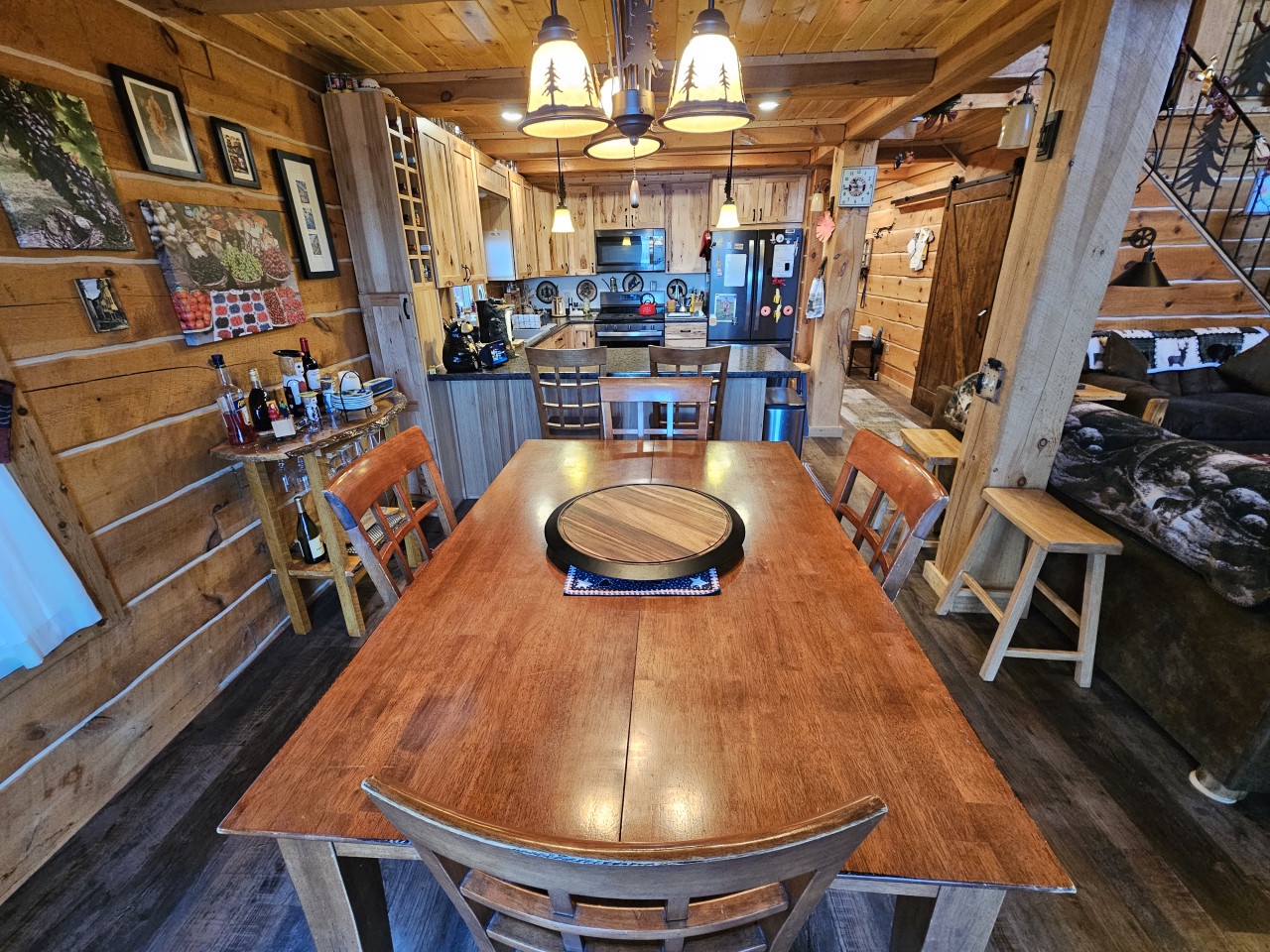 Gather around this handcrafted wooden table in your cozy cabin kitchen, where rustic charm meets modern convenience for memorable meals together.