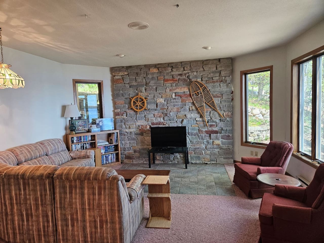 Cozy up by your stone fireplace with vintage decor and comfortable seating, where rustic charm meets modern comfort.