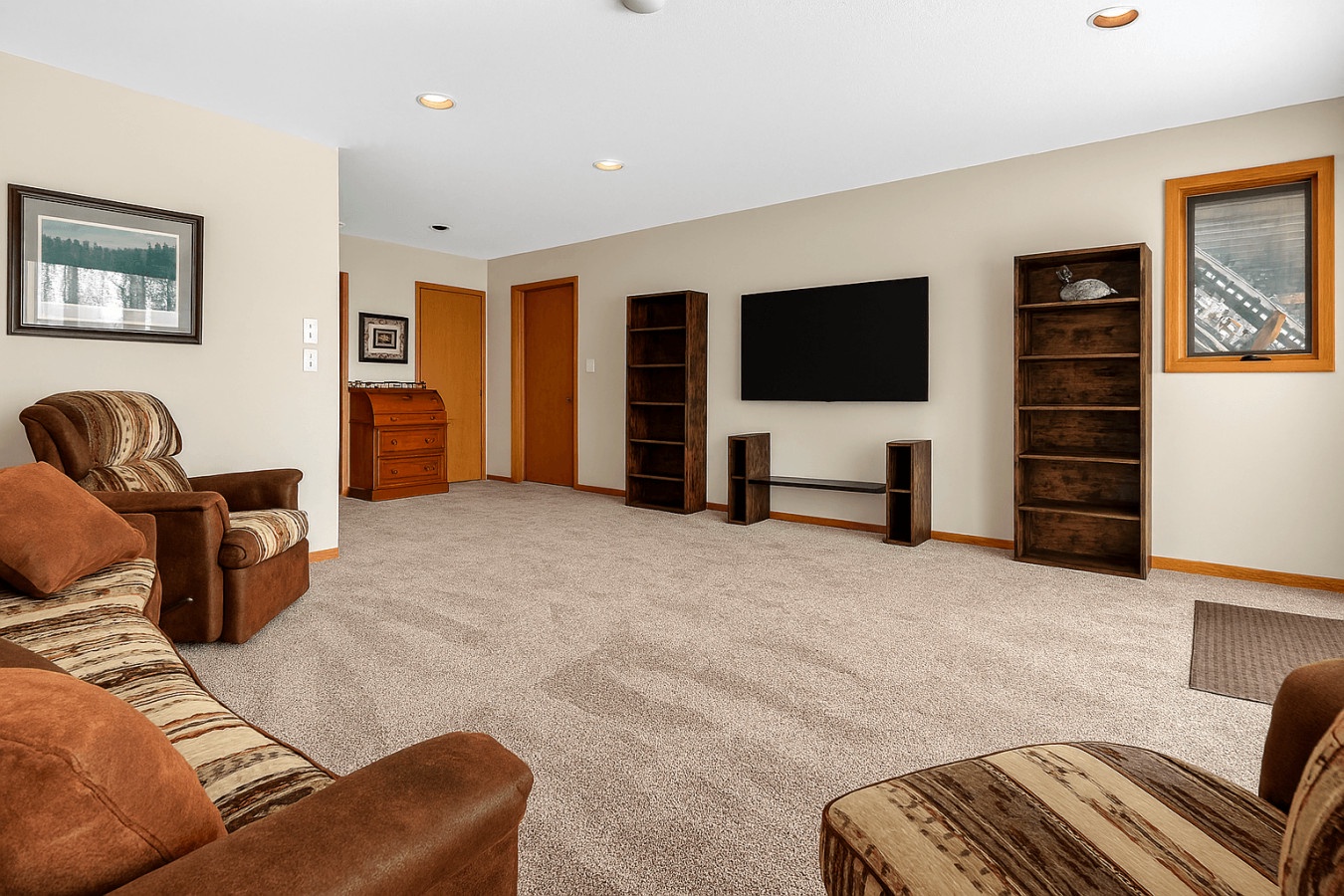 Sink into the plush seating of your spacious living room, where warm wood tones and soft lighting create the perfect atmosphere for relaxation.