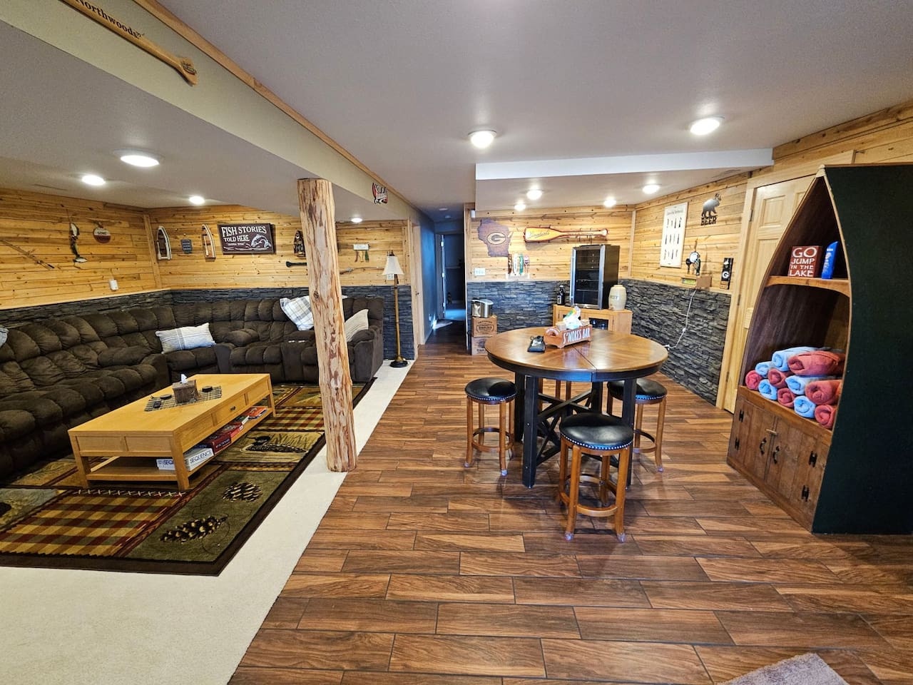 Your spacious game room features rustic charm with comfortable seating, high-top table, and creative boat-inspired storage for endless entertainment.