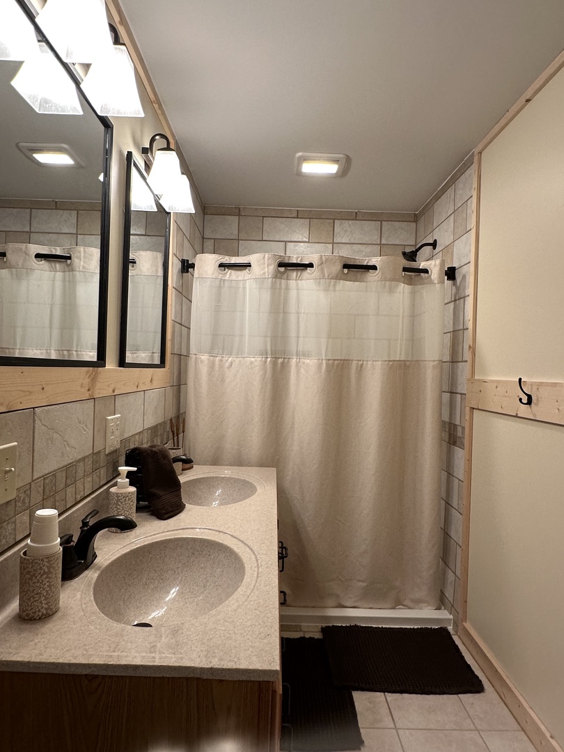 Unwind in your spa-like bathroom with dual glass sinks, spacious shower, and modern finishes that create a tranquil retreat.