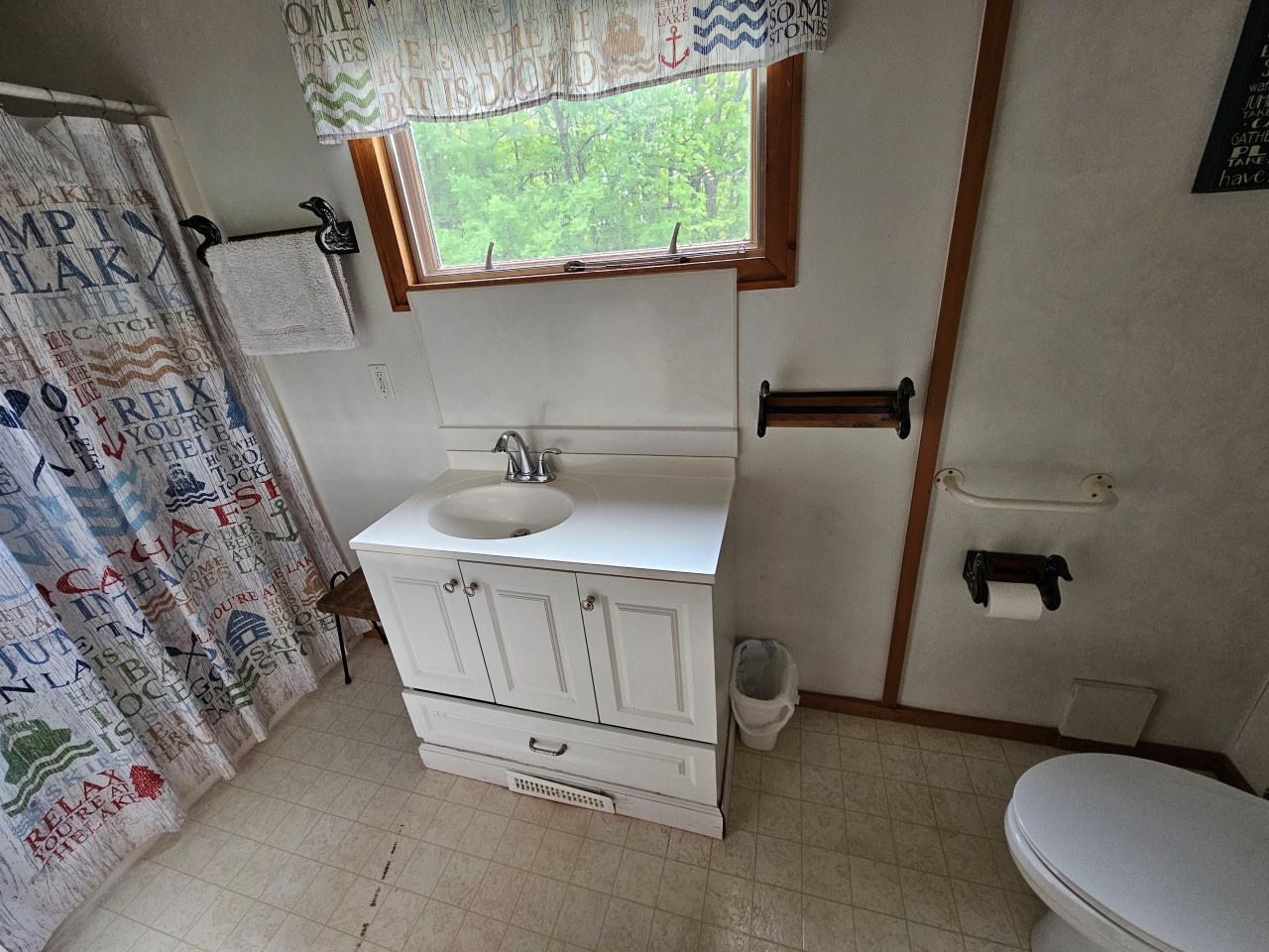 Your full bathroom features everything you need, from a relaxing shower to fresh towels, with a charming wooded view to start your mornings.