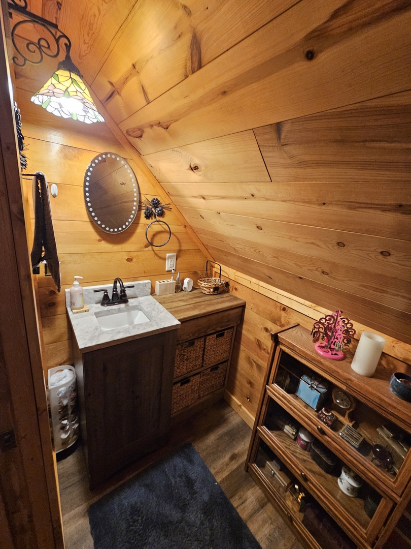 Step into your cozy log cabin bathroom where warm wood surrounds you and rustic charm meets comfort in this intimate space.