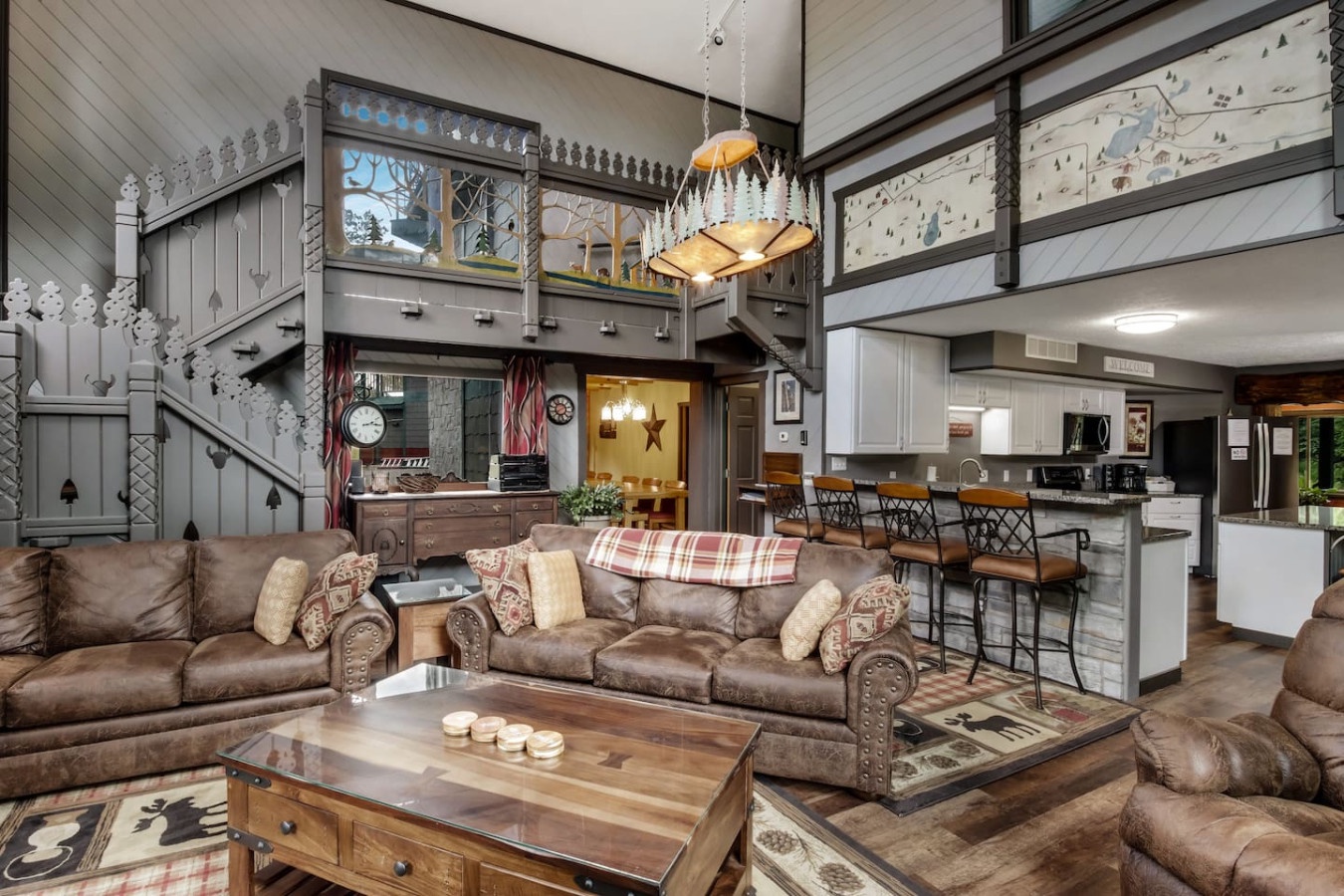 Sink into plush leather sofas in this stunning lodge-style great room, where rustic charm meets modern comfort for your perfect mountain getaway.