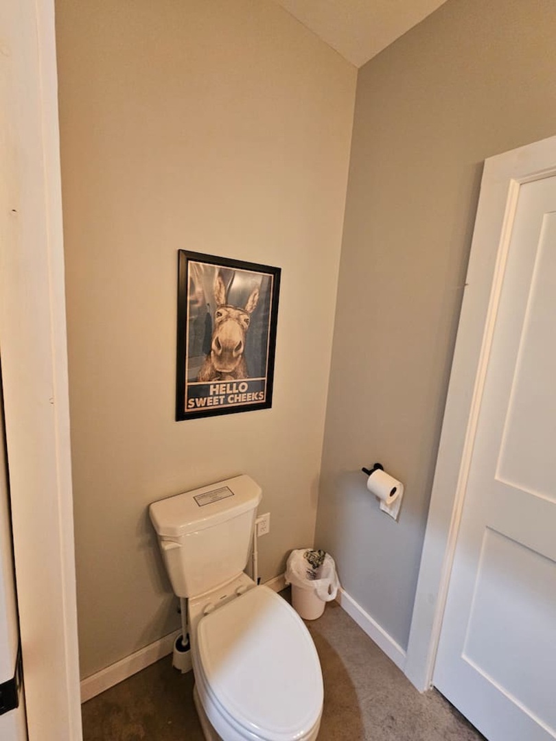 Your private powder room greets you with warm beige walls and playful donkey art that'll make you smile.
