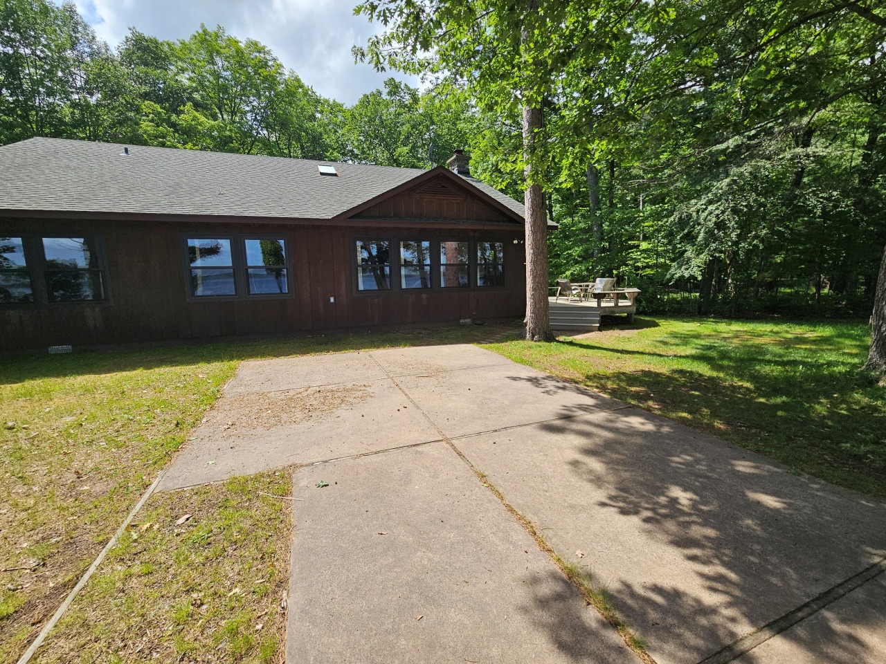 Charming lakefront cabin nestled among towering trees with dedicated parking and peaceful forest surroundings for your woodland retreat.