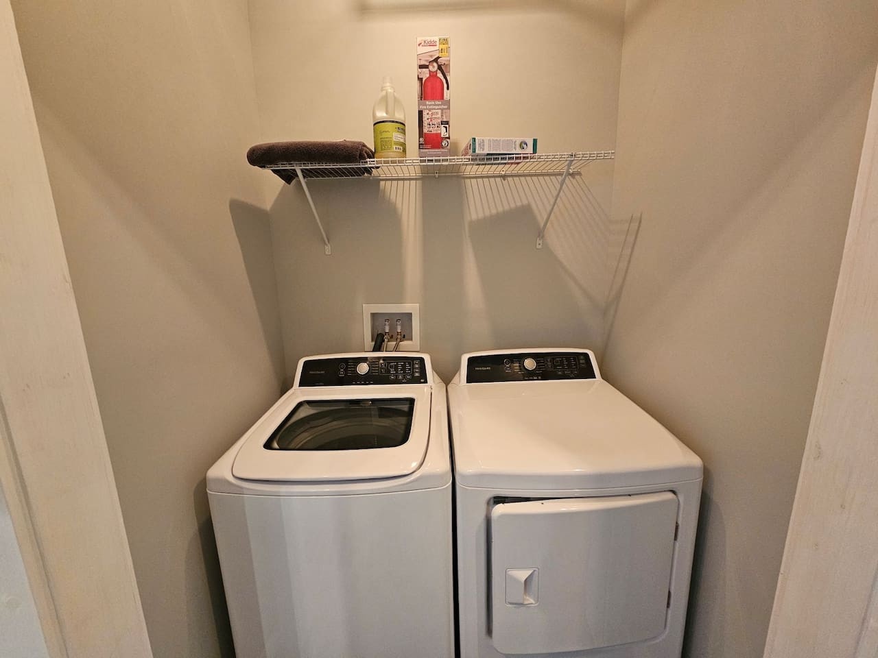 Your own washer and dryer await in this dedicated laundry closet, complete with storage shelf and cleaning supplies for ultimate convenience.