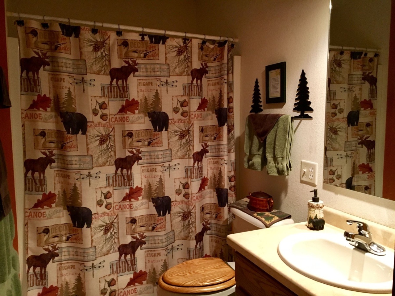 Unwind in your cozy cabin-themed bathroom, where rustic charm meets comfort with wilderness-inspired décor and thoughtful touches.