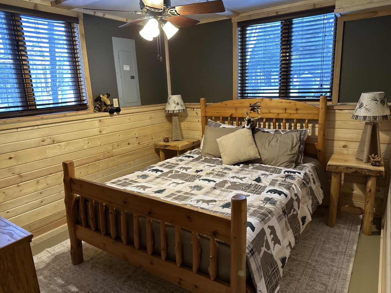 Cozy up in rustic charm with handcrafted wooden furniture and wilderness-themed bedding for your mountain retreat.