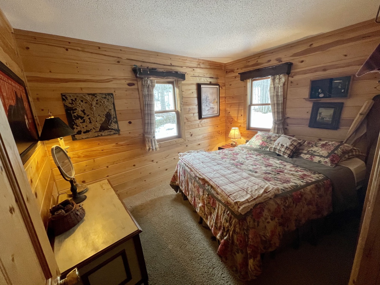 Cozy log cabin bedroom with warm wood walls creates your perfect mountain retreat for restful nights.