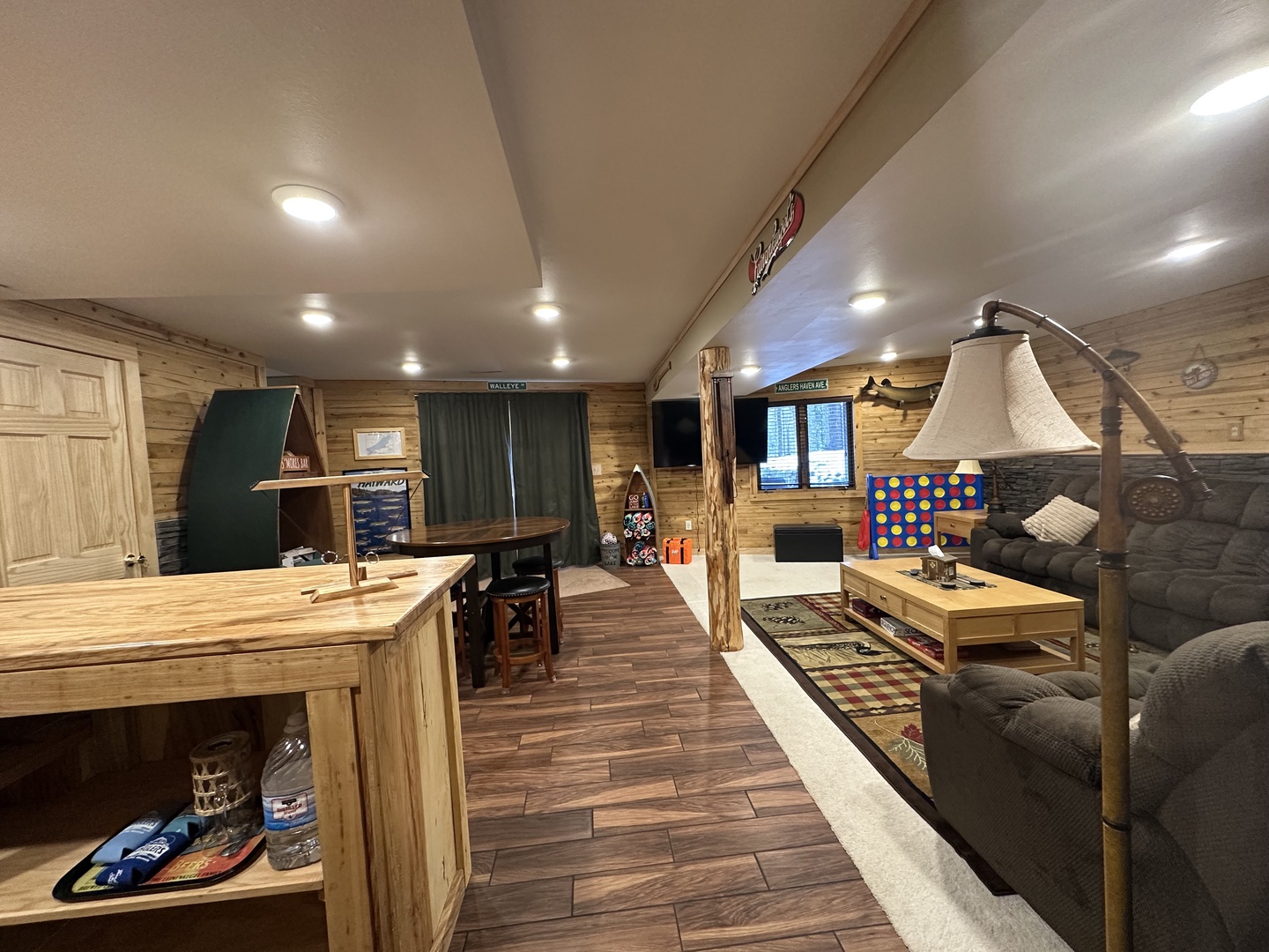 Your cozy basement retreat features warm wood paneling, comfortable seating, and entertainment space perfect for relaxing evenings indoors.