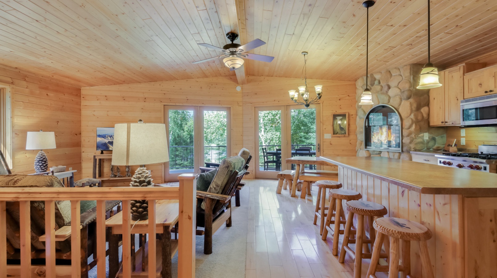 Gather around the spacious kitchen island or relax by your cozy fireplace in this warm, wood-wrapped cabin retreat.