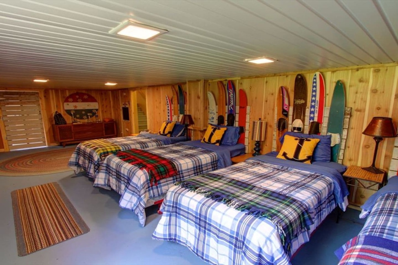 Cozy ski-themed bedroom with comfortable beds and colorful plaid bedding creates the perfect alpine retreat after your adventures.