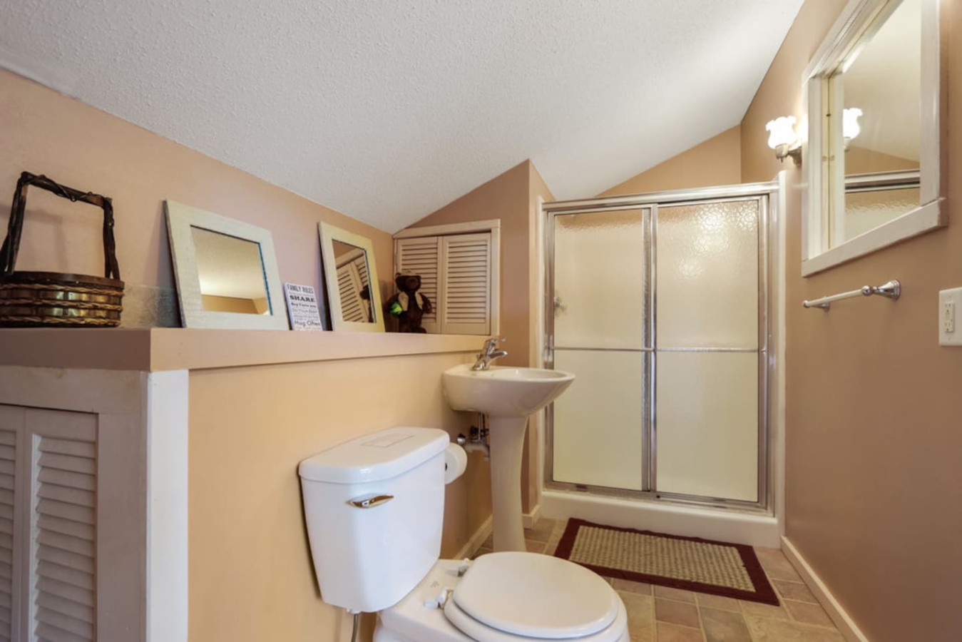 Your private bathroom features a spacious shower, convenient amenities, and warm lighting for comfortable daily routines.