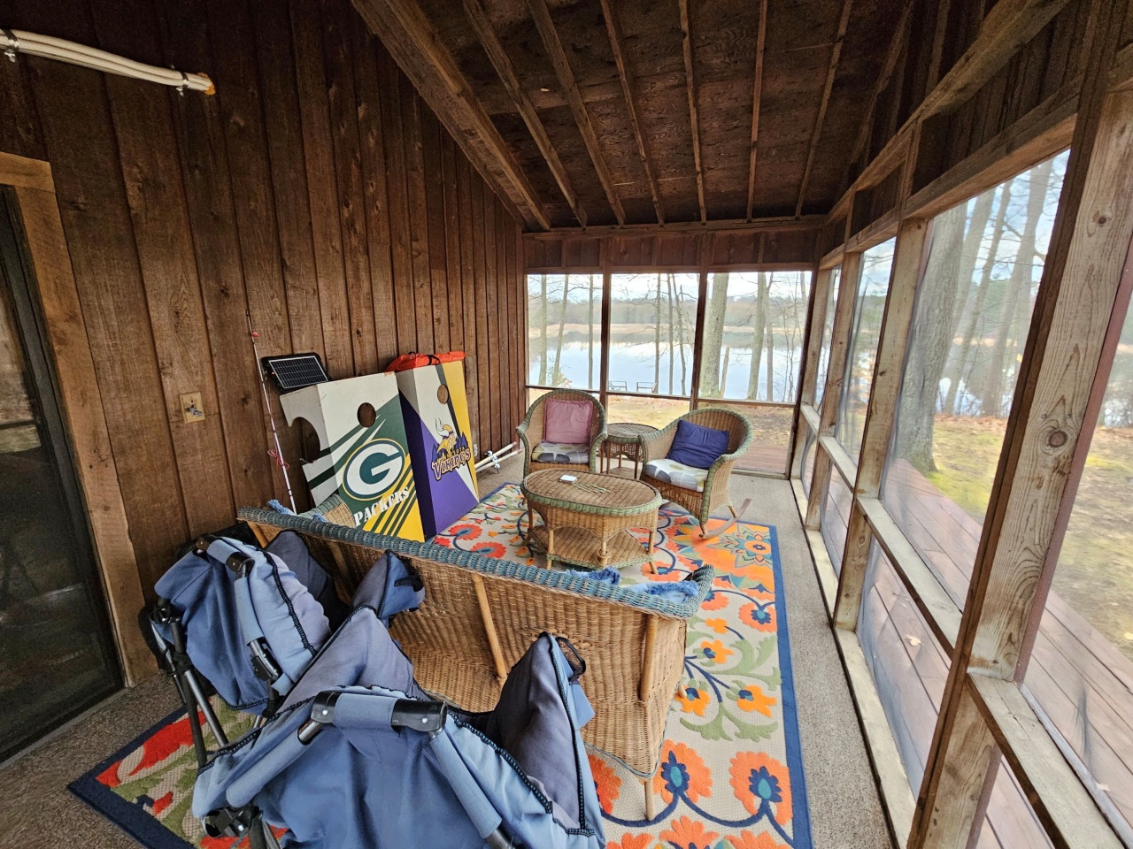 Unwind in your private screened porch with cozy wicker seating and stunning lake views through floor-to-ceiling windows.