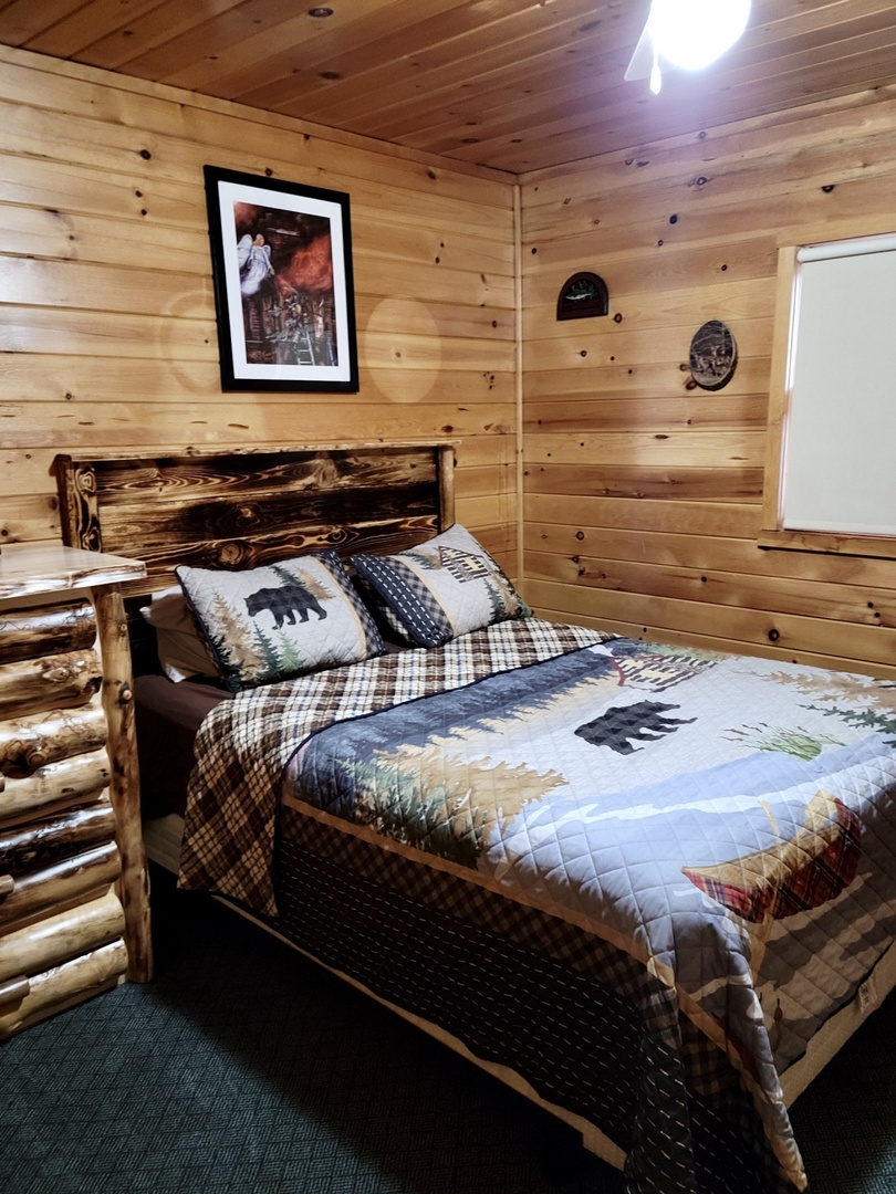 Unwind in your cozy log cabin bedroom with handcrafted log bed frame and charming woodland-themed quilted bedding.