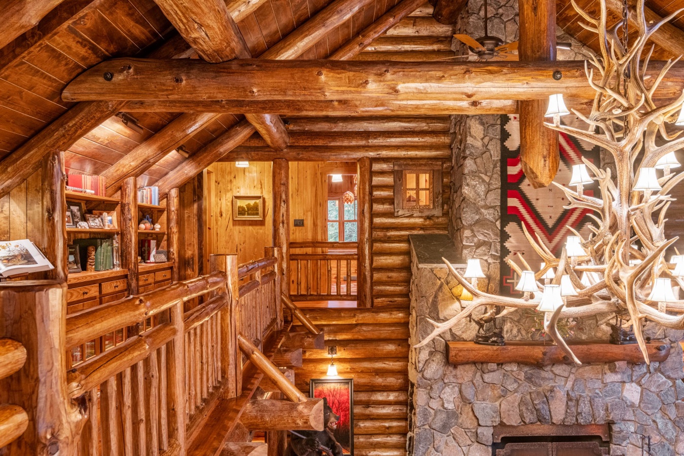 Step into this stunning log cabin where rustic charm meets cozy elegance—rich wood beams overhead and a magnificent stone fireplace create your perfect mountain retreat.