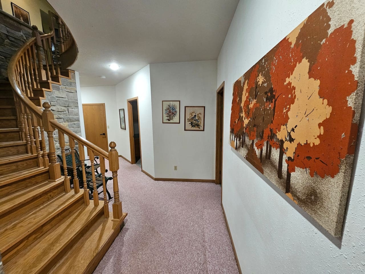 You'll appreciate the thoughtful touches throughout, from the beautiful autumn artwork to the crafted wooden staircase that makes this feel like home.