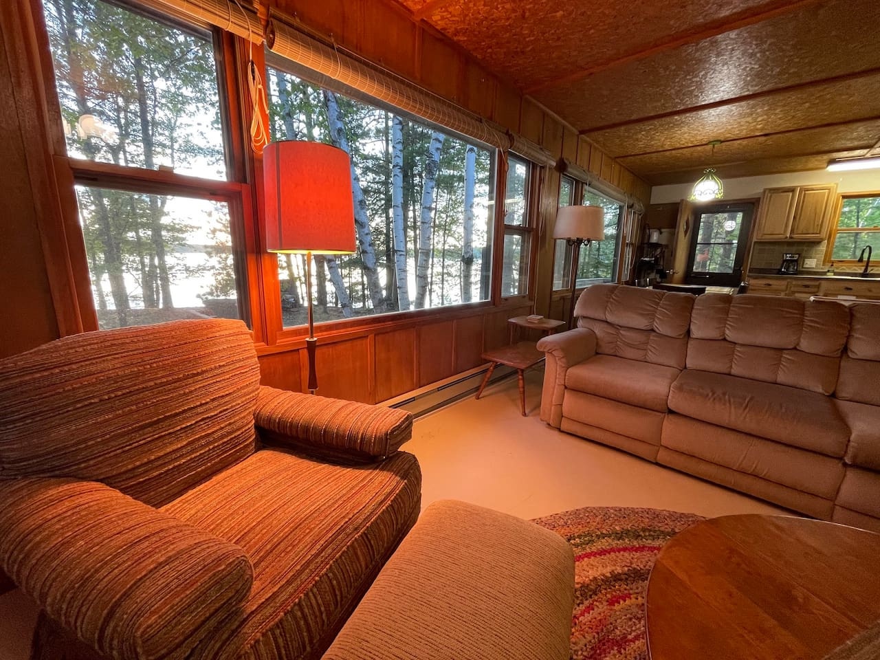 Sink into plush seating and gaze through panoramic windows at towering forest views from your cozy retreat.