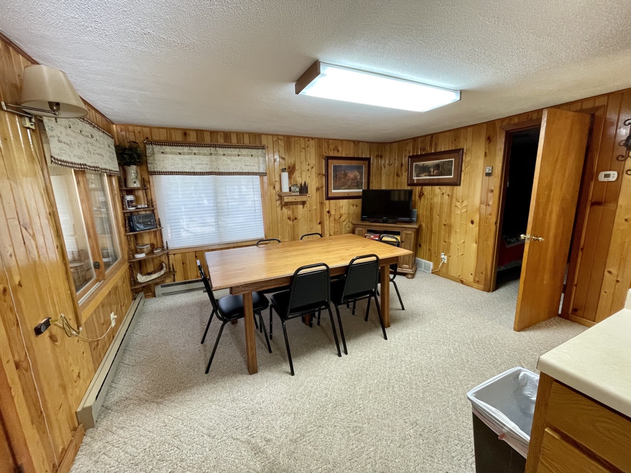 Gather around the spacious dining table in this warm, wood-paneled room where your group can enjoy meals and quality time together.