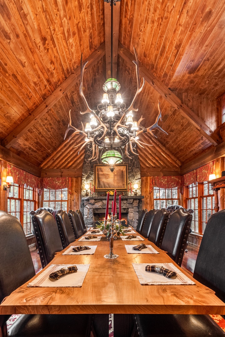 Gather around this stunning rustic dining room where soaring timber ceilings and an antler chandelier create the perfect mountain lodge atmosphere for your group meals.