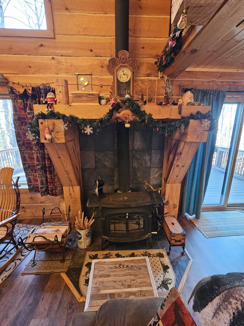 Cozy up beside the festive wood-burning stove, beautifully decorated with holiday garlands and surrounded by rustic charm.
