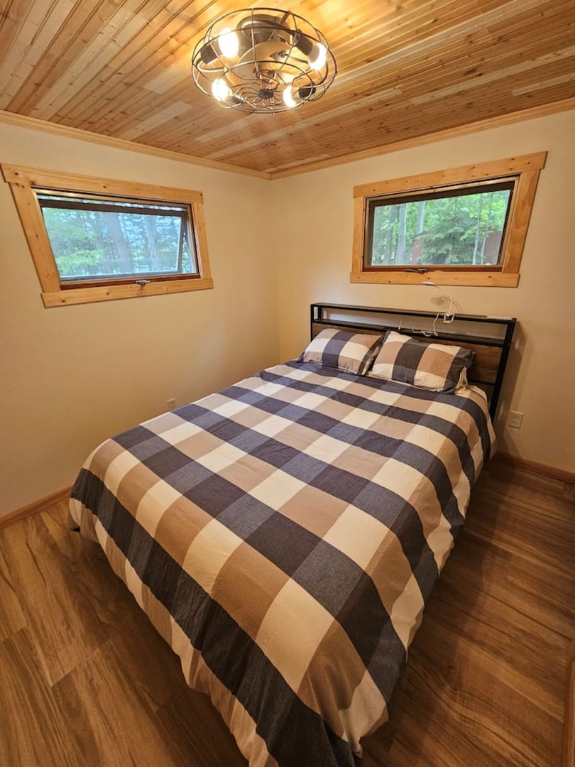 Drift off to sleep under the warm wood ceiling, surrounded by forest views through your windows.