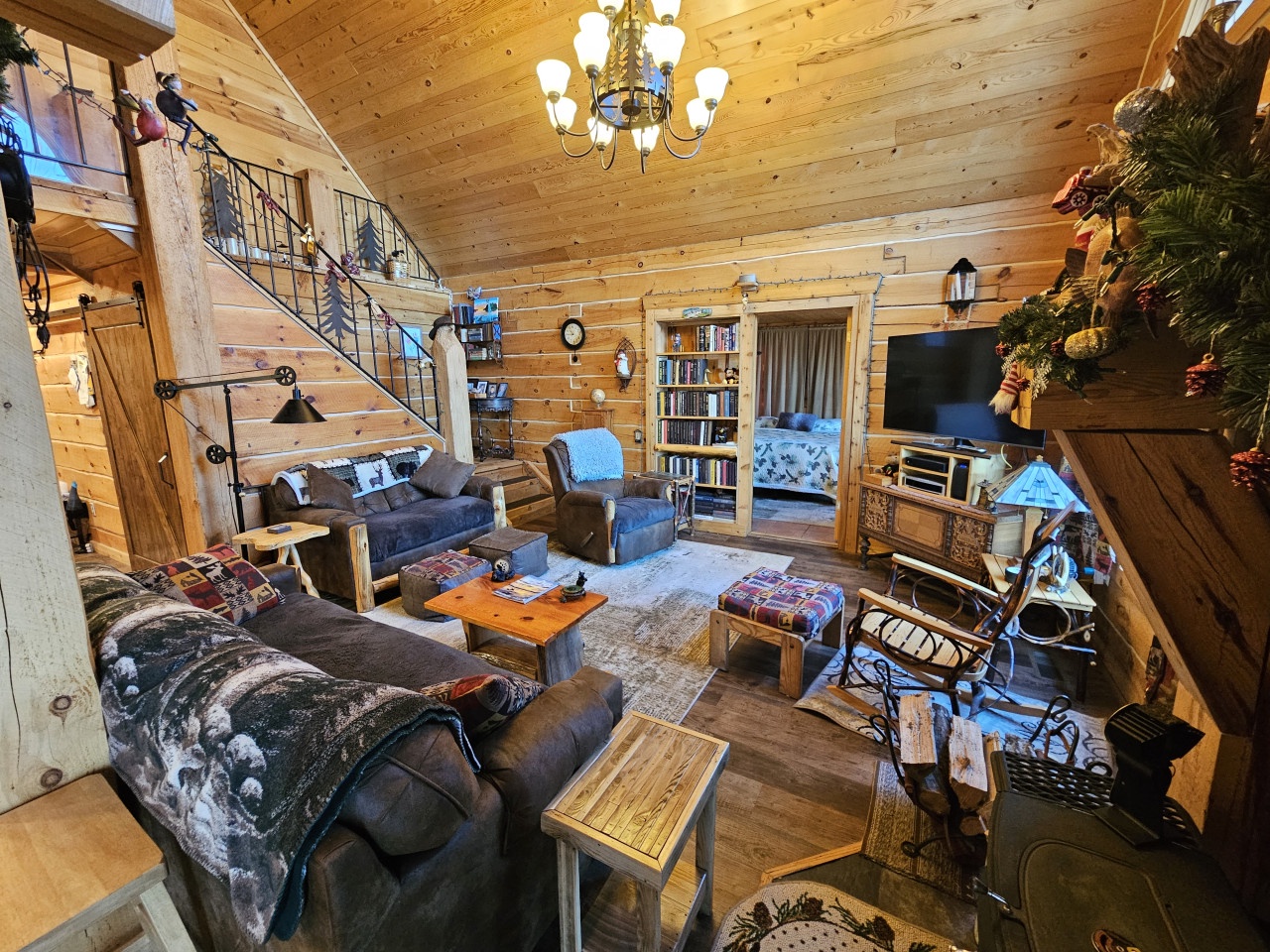 Unwind in this cozy log cabin living room where rustic charm meets modern comfort. Sink into plush sofas surrounded by warm wood and thoughtful touches.