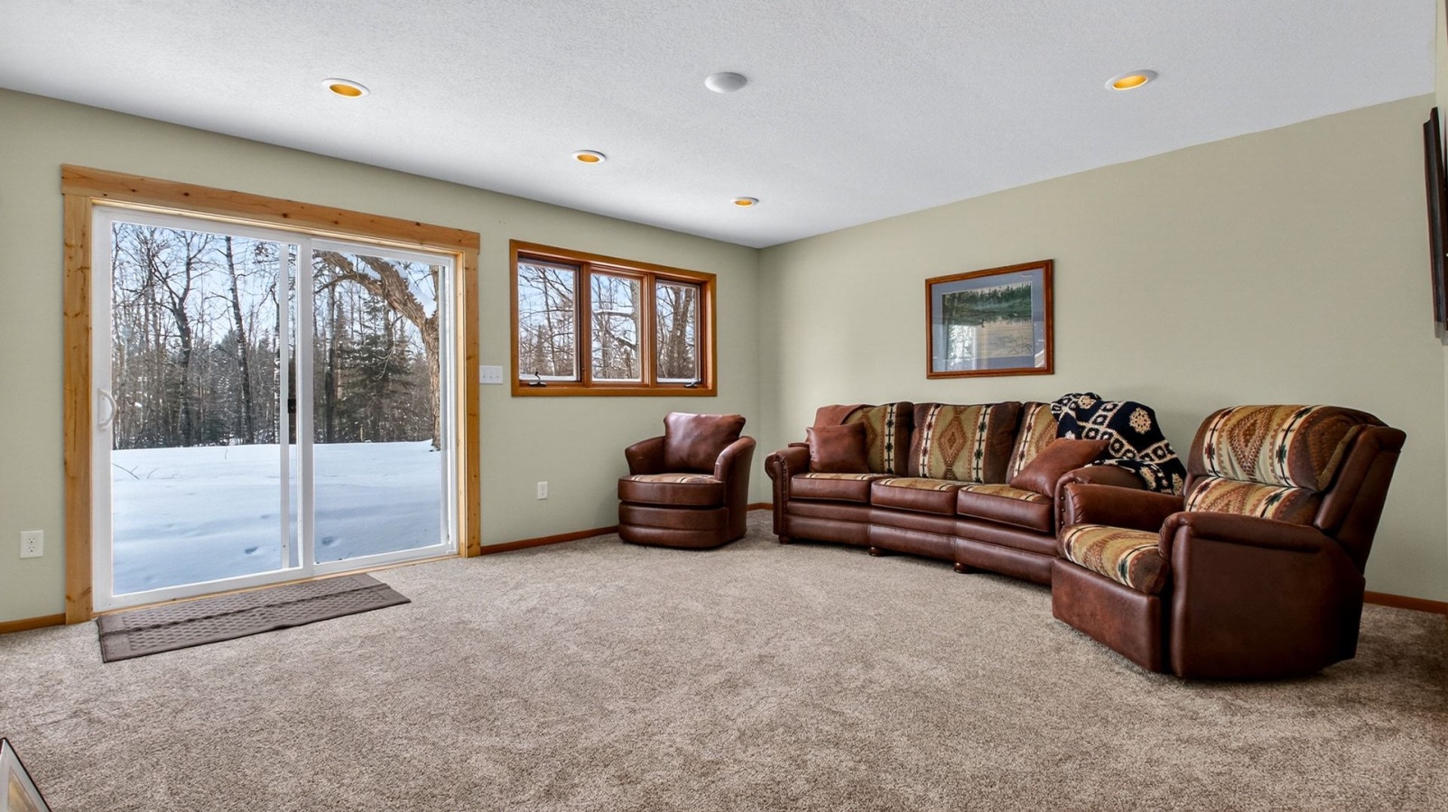 Sink into plush leather seating while gazing at pristine winter woods through floor-to-ceiling windows in your spacious retreat.